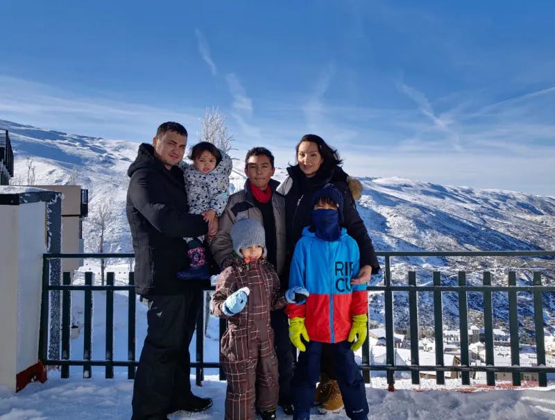 Family standing on a balcony in winter