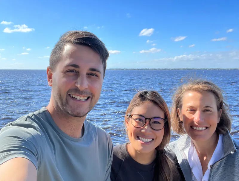 Selfie of a man and two women by the water