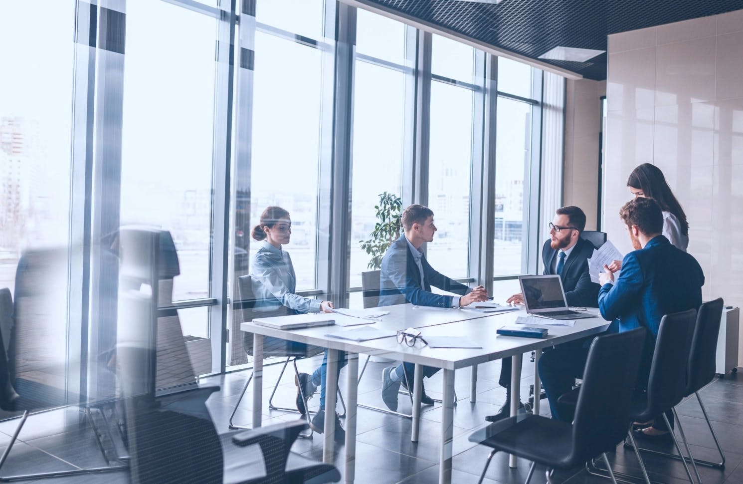 Financial investors meet in an office to discuss market strategy