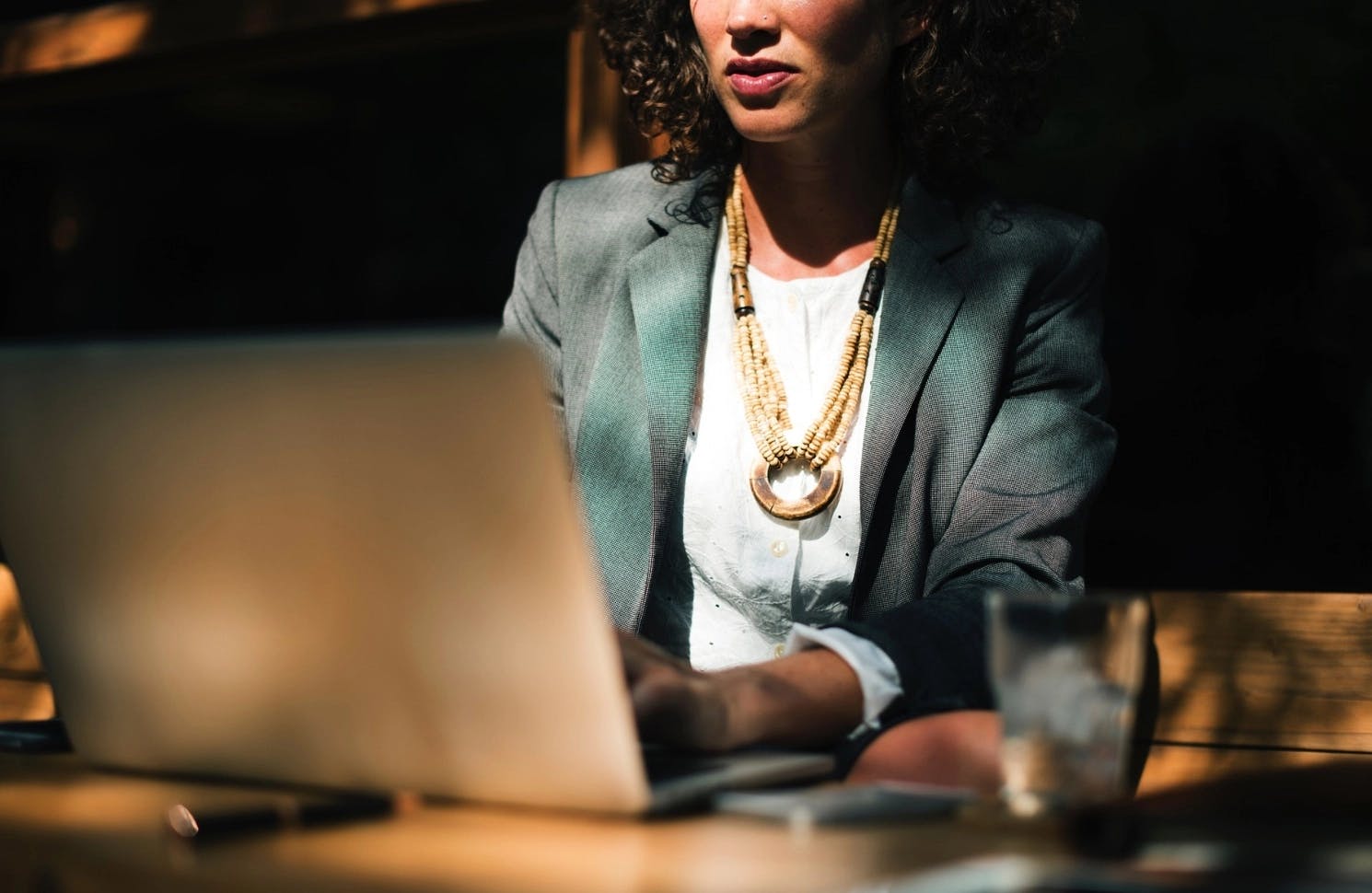 Female CMO of company sitting at table working on her laptop