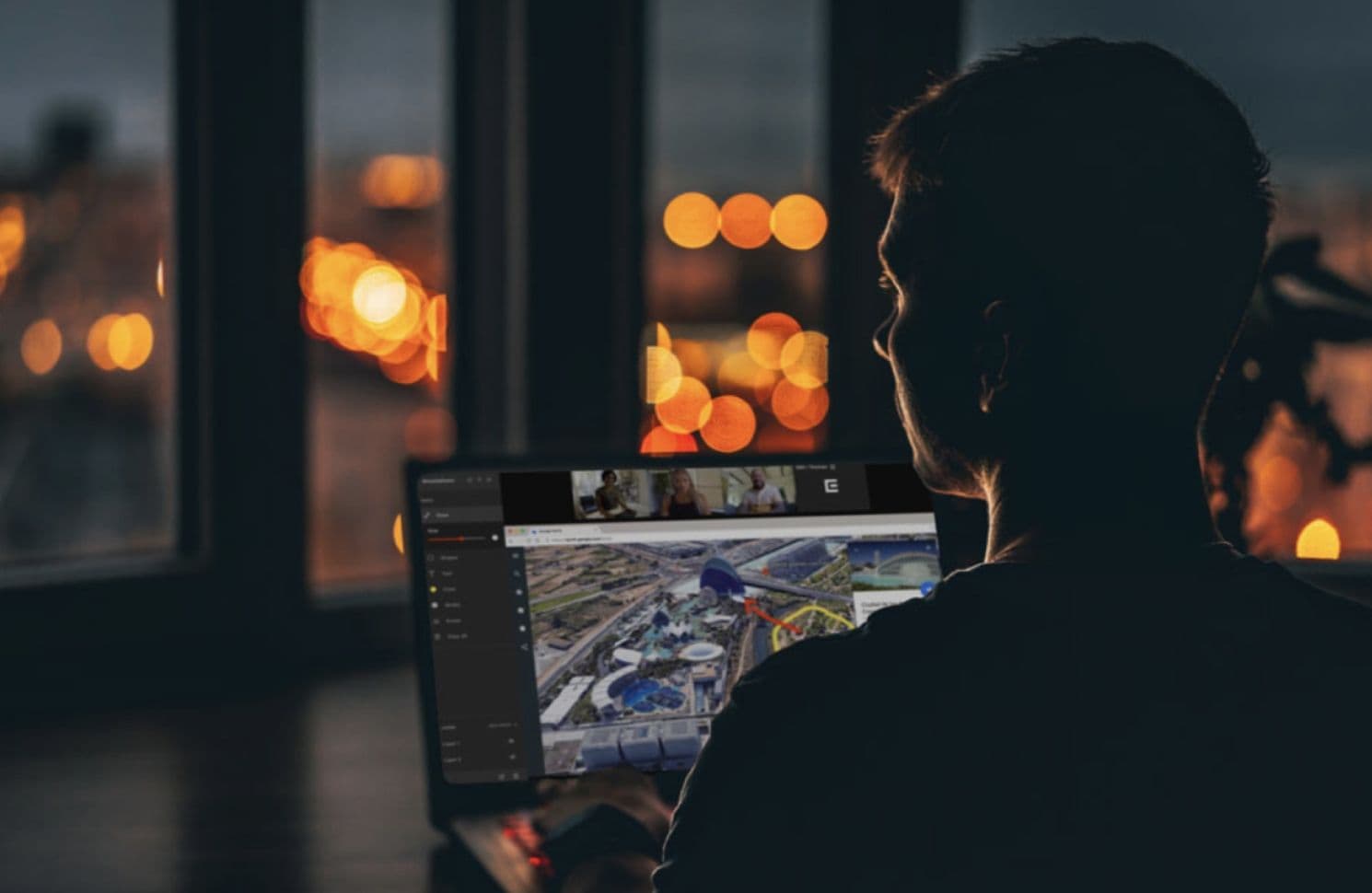 Man sitting in front of laptop, remotely collaborating with video production team