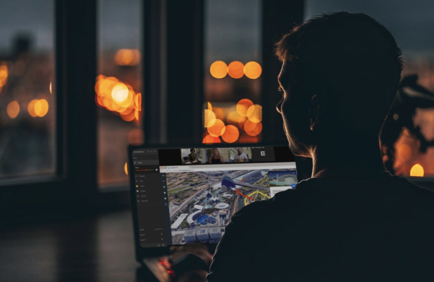 Man sitting in front of laptop, remotely collaborating with video production team