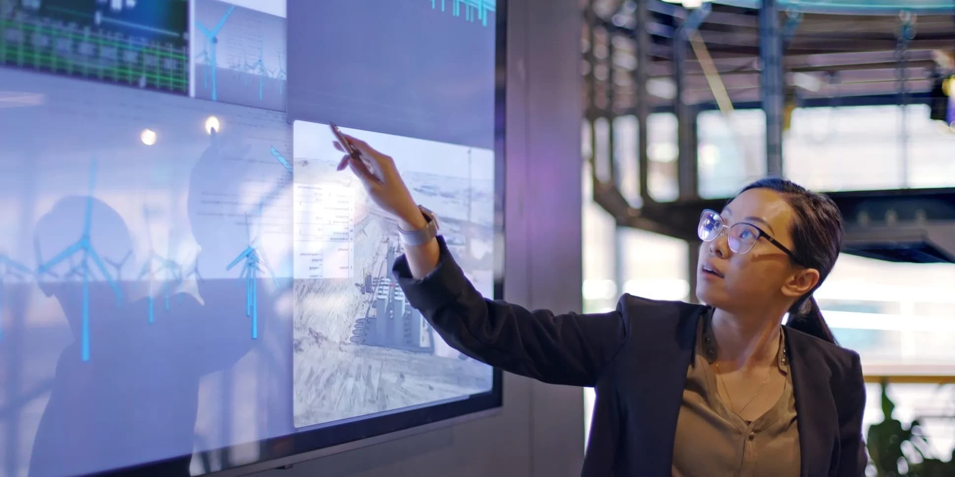 Business woman presenting data on a large screen