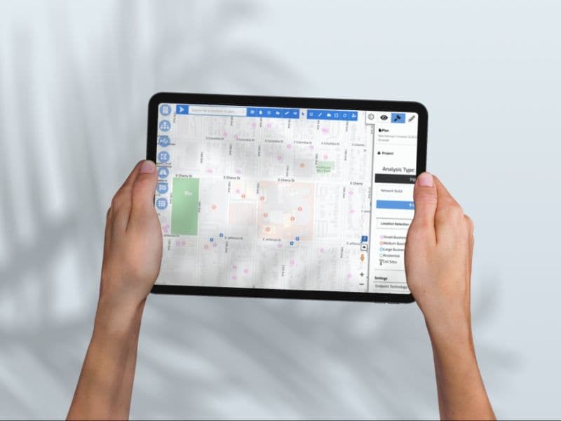 Person holding tablet with SaaS application dashboard