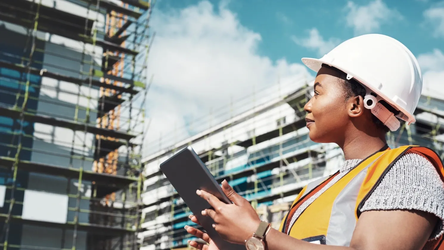 female inspecting commercial building with device